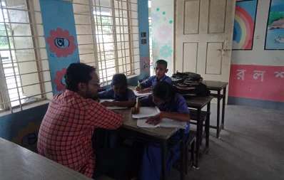 A teacher talking to students at a school in Pabna. Photo: Dhaka Tribune