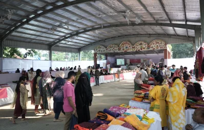 People walk and observe products by women entrepreneurs at the `Festival of Enterprise` held at Boishakhi Mancha in Shilpacharya Zainul Abedin Park, Mymensingh on Monday, October 16, 2023. Photo: Courtesy