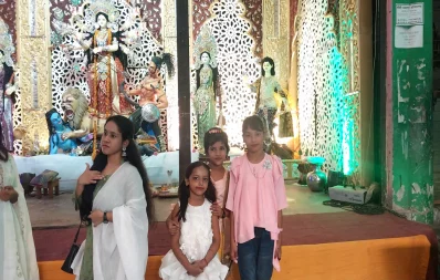 Children are seen posing for a photo in front of a mandap in a temple in Dhaka on Monday, October 23, 2023. Photo: Famiha Suhrawardy/Dhaka Tribune