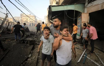 People react as Palestinians search for casualties at the site of an Israeli strike on a residential building in Gaza City, October 25, 2023. Photo: Reuters