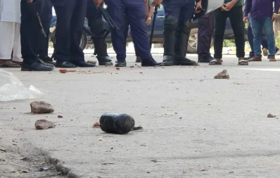 A cocktail is seen in front of policemen in Dhaka&rsquo;s Matuail area on Tuesday, October 31, 2023. Photo: Mahmud Hossain Opu/Dhaka Tribune