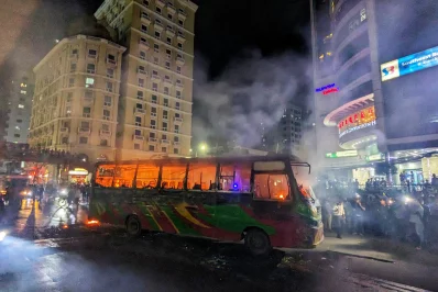 People look on as a bus burns after it was set on fire in the Banglamotor area of Dhaka on Sunday, November 5, 2023. Photo: Mahmud Hossain Opu/Dhaka Tribune