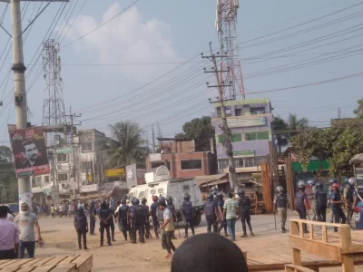 The image police in alert position with an armoured personnel carrier (APC) during a clash with RMG workers in Gazipur on Wednesday, November 8, 2023. Photo: Dhaka Tribune