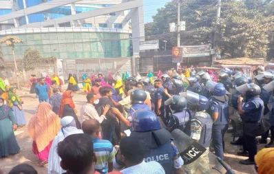 A clash takes place between police and garment workers following the government fixing minimum wage of garment workers at Tk12,500 in Savar on Thursday, November 9, 2023. Photo: Dhaka Tribune