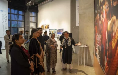 Representatives of the Office of the United Nations Resident Coordinator in Bangladesh (UNRC) and the Drik Picture Library look at photos at the opening of a photography exhibition titled “Rage and Hope” on Thursday, December 14, 2023. Photo: Dhaka Tribune