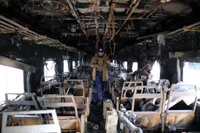 An official inspects the inside of a train that was set on fire in Tejgaon Railway Station in Dhaka on Tuesday, December 19, 2023. Photo: Mahmud Hossain Opu/Dhaka Tribune