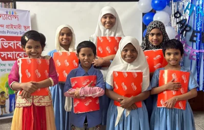 The undated image shows students of Bidyanondo school holding notebooks made using election posters. Photo: Bidyanondo
