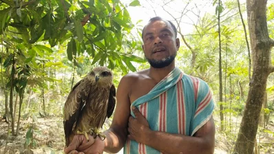 A local pose for a photograph with a kite recently. Photo: Bangla Tribune
