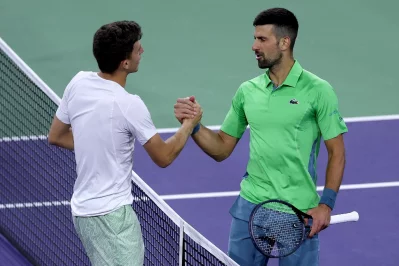 Nardi is congratulated by Djokovic Photo: AFP