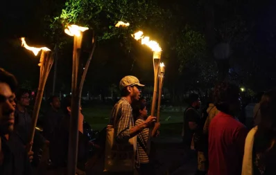 A student is seen holding a torch during a procession demanding justice for Fairuz Abontika at Dhaka University on Saturday, March 16, 2024. Photo: Ahadul Karim Ahad/Dhaka Tribune