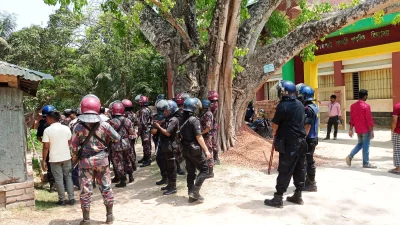 Members of Border Guard Bangladesh (BGB) and Bangladesh Police inspecting the temple following the mob beating in in Dumain union under Madhukhali upazila of Faridpur on Friday, April 19, 2024. Photo: Dhaka Tribune