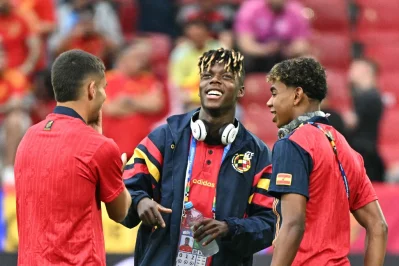 Nico Williams (C) and Lamine Yamal (R) stand on the pitch before the Georgia game