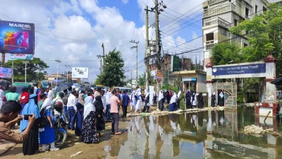 The image shows students entering exam centres braving floods water in Sylhet on Tuesday, July 9, 2024. Photo: Dhaka Tribune