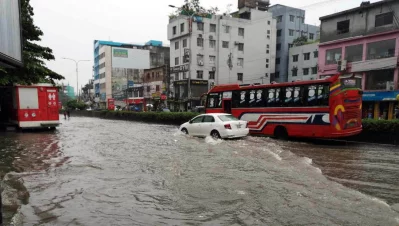 Vehicles ply a waterlogged road in Dhaka on Friday, July 12, 2024. Photo: Bangla Tribune