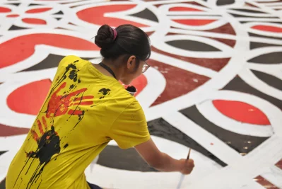 At the site, students of the Fine Arts department were painting intricate alpana motifs on the roads leading to the Shaheed Minar. Photo: Mehedi Hasan/Dhaka Tribune