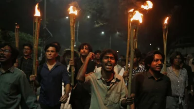 Torch procession held at DU protesting police obstruction of anti-rape march