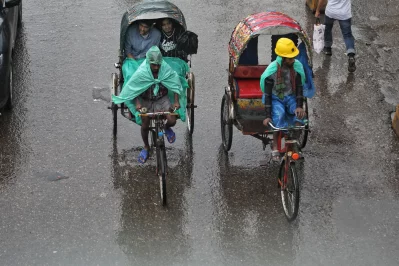Pedestrians navigate waterlogged streets in the New Market area as daylong rain, triggered by a low-pressure system over the Bay of Bengal, brings both relief and disruption to Dhaka residents on Thursday, May 29, 2025. Photo: Ahadul Karim Khan/Dhaka Tribune