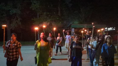 JU students held a torch rally Saturday night, July 12, 2025, protesting nationwide violence under the banner- Jahangirnagar Against Repression. Photo: Dhaka Tribune