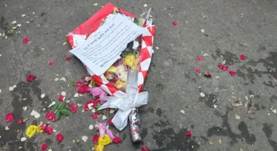 Flower bouquet lying at the entrance to Dhanmondi 32. Photo: Bangla Tribune