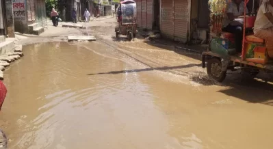 Pothole-ridden roads, broken drains, and frequent waterlogging have turned daily life in Ashkona into a struggle, with residents facing accidents, health risks, and long commutes. Photo: Dhaka Tribune