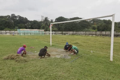 Workers tend to the playing surface at Shaheed Barkat Stadium before the league kick-off (Photo: Ahadul Karim Khan/Dhaka Tribune)