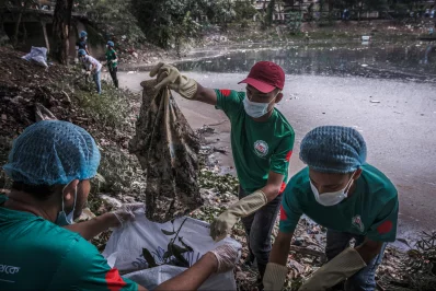 Volunteers clean one of the canals in a neighbourhood in northern Dhaka