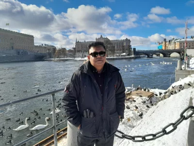 The writer standing at bird feeding station in Stockholm.