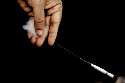 Hand-spinning cotton fibers into yarn using a traditional hand spindle. Photo: Dhaka Tribune