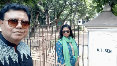 The author and his daughter outside `Pratichi` during a 2019 visit to Santiniketan, West Bengal, India. Located on the Visva-Bharati University campus, this home of Nobel Laureate Amartya Sen was built by his father, Ashutosh Sen, whose initials `A T Sen` still mark the gate pillar. Photo: Dhaka Tribune/Collected