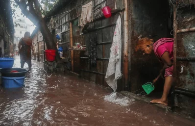 Residents of Master Bari in West Shahidnagar endure severe waterlogging after heavy rain disrupted daily life, leaving homes flooded and making it difficult for children, the elderly and workers to move around in Dhaka on Sunday. Photo: Ahadul Karim Khan/Dhaka Tribune