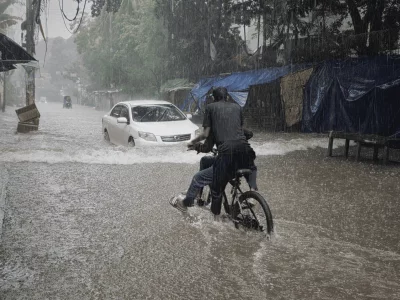 A cyclist rides through floodwater in Mirpur 10 as continuous monsoon rain leaves roads submerged, forcing commuters to navigate difficult conditions in Dhaka on Sunday. Photo: Dhaka Tribune