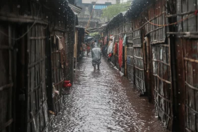 Residents make their way through knee-deep water after heavy rainfall inundated roads, alleys and homes in West Shahidnagar, leaving the neighborhood severely waterlogged in Dhaka on Sunday. Photo: Ahadul Karim Khan/Dhaka Tribune