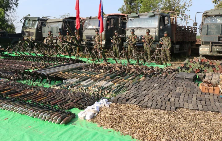 Myanmar-Arakan-ArmyFile photo: Arakan Army troops pose with arms, ammunition and military trucks seized from the junta in Myebon Township. Photo: Collected