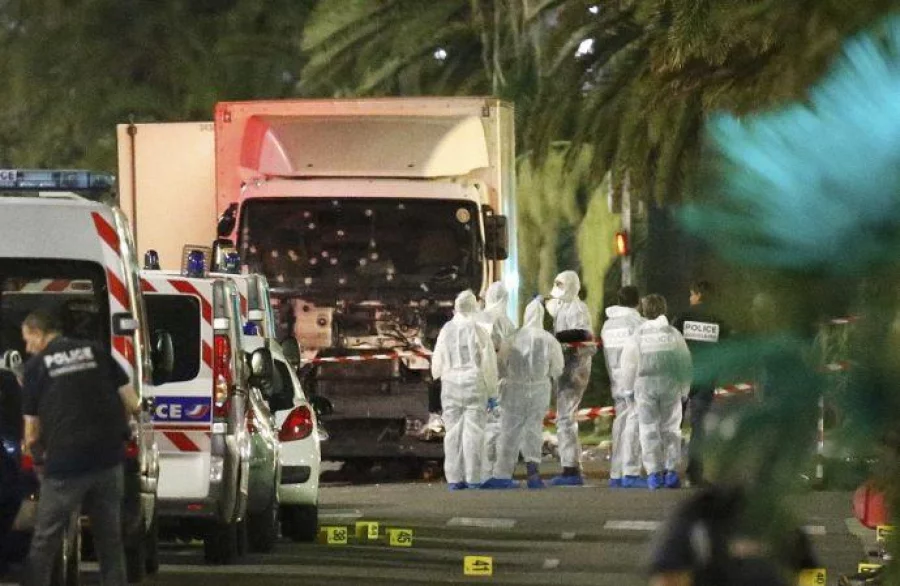 French police forces and forensic officers stand next to a truck July 15, 2016 that ran into a crowd celebrating the Bastille Day national holiday on the Promenade des Anglais killing at least 60 people in Nice, France, July 14. REUTERS/Eric Gaillard TPX IMAGES OF THE DAY