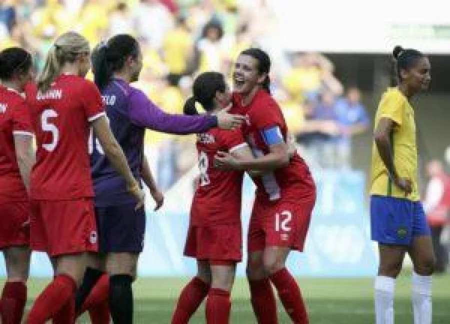 2016 Rio Olympics - Soccer - Final - Women's Football Tournament Bronze Medal Match - Brazil v Canada - Corinthians Arena - Sao Paulo, Brazil - 19/08/2016. Christine Sinclair (CAN) of Canada and Diana Matheson (CAN) of Canada celebrate winning the match as Poliana (BRA) of Brazil reacts. REUTERS/Paulo Whitaker FOR EDITORIAL USE ONLY. NOT FOR SALE FOR MARKETING OR ADVERTISING CAMPAIGNS.