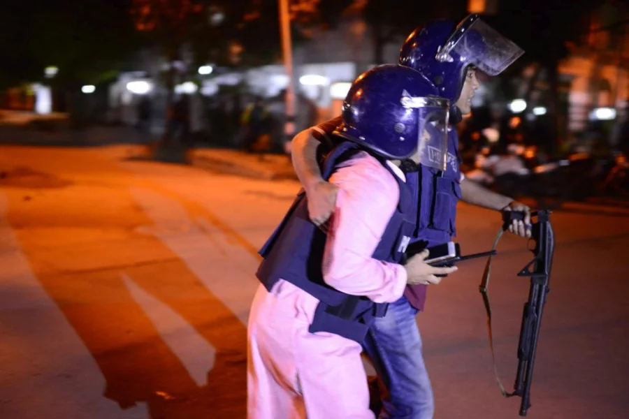 A policeman is seen helping a apparently- injured colleague in civil outfit during the Holey Artisan Bakery attack in Dhaka's upscale Gulshan area on July 1, 2016 Dhaka Tribune/Mahmud Hosain Opu