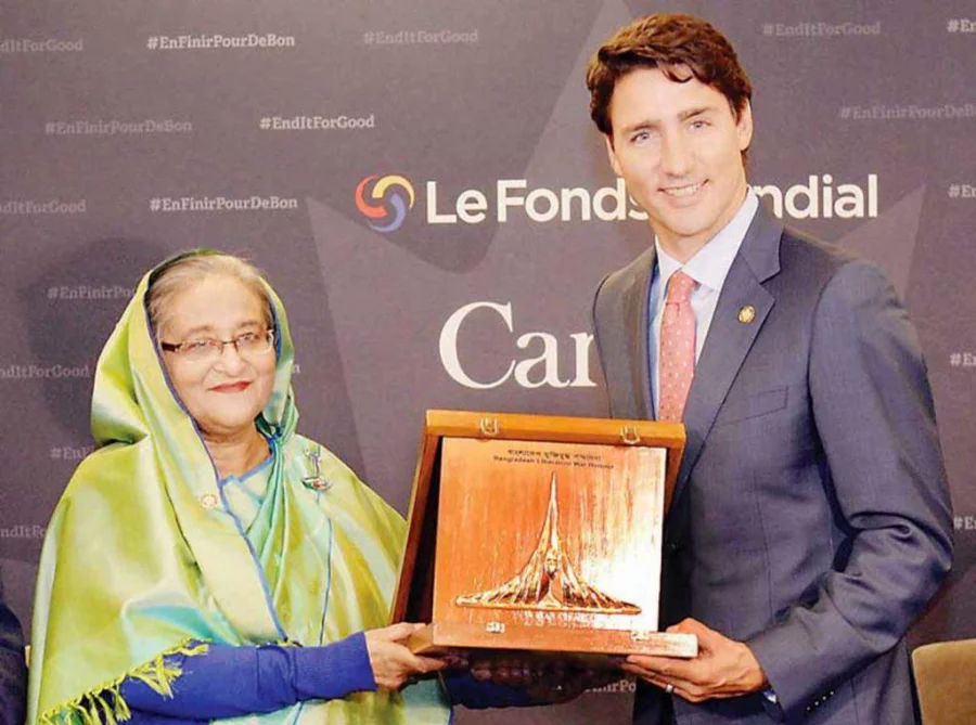 Prime Minister Sheikh Hasina hands the Friends of Liberation War Honour crest to Canadian Prime Minister Justin Trudeau, son of former Canadian prime minister Pierre Elliott Trudeau, in Montreal, Canada on Friday PID