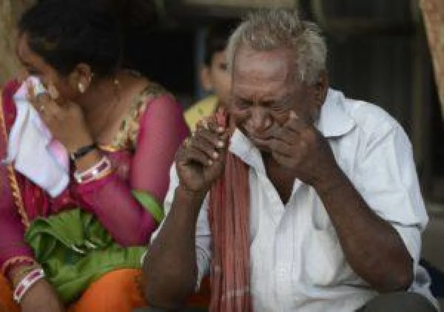 Indian relatives of one of those convicted over religious rioting react outside a court in Ahmedabad on June 17, 2016. An Indian court jailed 11 Hindus for life on June 17 over the massacre of dozens of Muslims in Gujarat state 14 years ago, when Prime Minister Narendra Modi was chief minister. The court sentenced 12 others to seven years in jail over the murder of 69 Muslims who were hacked and burnt to death in a residential complex in the city of Ahmedabad in Gujarat, among them women and children. / AFP PHOTO / SAM PANTHAKY