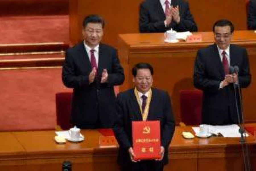 Chinese President Xi Jinping (L) and Chinese Premier Li Keqiang (R) applaud after honouring communist party member (front) duringThe Celebration Ceremony of the 95th Anniversary of the Founding of the Communist Party of China at the Great Hall of the People in Beijing on July 1, 2016. China's Communist Party take the ruling organisation's membership to almost 88 million and the anniversary of the Party's founding falls on July 1. / AFP PHOTO / WANG ZHAO