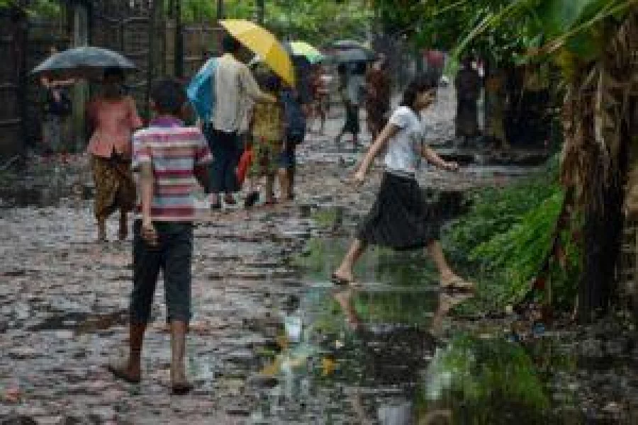 In this photograph taken on September 7, 2016, minority Muslim Rohingya residents walk on a road at the Aung Mingalar displacement camp in Sittwe after the Rakhine State has been effectively split on religious grounds between Buddhists and Muslims since bouts of communal violence tore through the state in 2012, killing scores and forcing tens of thousands to flee. Anti-Muslim sentiment runs high in the impoverished region, fanned by hardline Buddhist nationalists who revile the Rohingya and are viscerally opposed to any move to grant them citizenship. They insist the roughly one-million strong group are intruders from neighbouring Bangladesh, even though many can trace their ancestry in Myanmar back generations. / AFP PHOTO / ROMEO GACAD