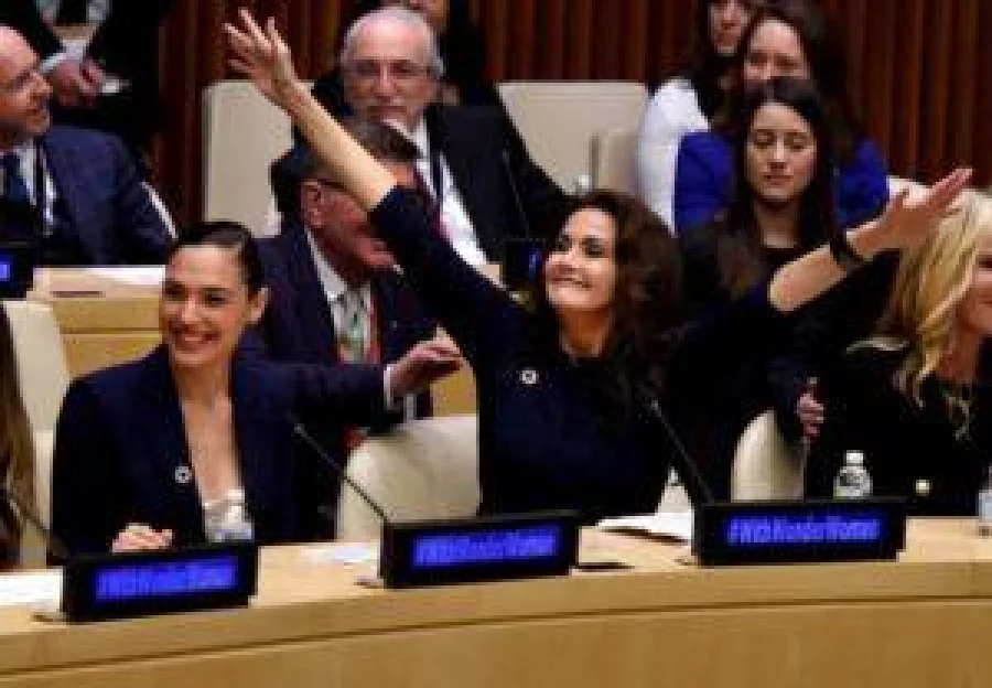 Actors Gal Gadot (L) and Lynda Carter cheer as the UN names the comic character Wonder Woman its Honorary Ambassador for the Empowerment of Women and Girls during a ceremony at the United Nations Economic and Social Council Chamber on October 21, 2016, in New York. Gadot played Wonder Woman in recent films, while Carter portrayed the character on television in the 1970s. The honorary title comes as Wonder Woman turns 75 years old. / AFP PHOTO / TIMOTHY A. CLARY