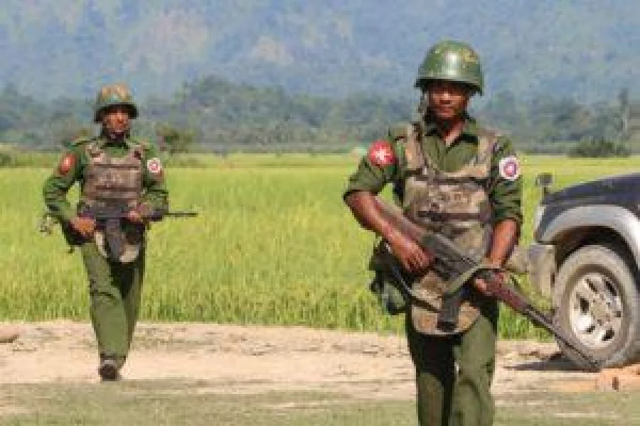 In this photograph taken on October 21, 2016, armed Myanmar army soldiers patrol a village in Maungdaw located in Rakhine State as security operation continue following the October 9, 2016 attacks by armed militant Muslim. The United Nations called for an investigation into claims Myanmar troops have been killing civilians and torching villages in northern Rakhine, as reports emerged thousands of Rohingya had been forced from their homes. / AFP PHOTO / STR