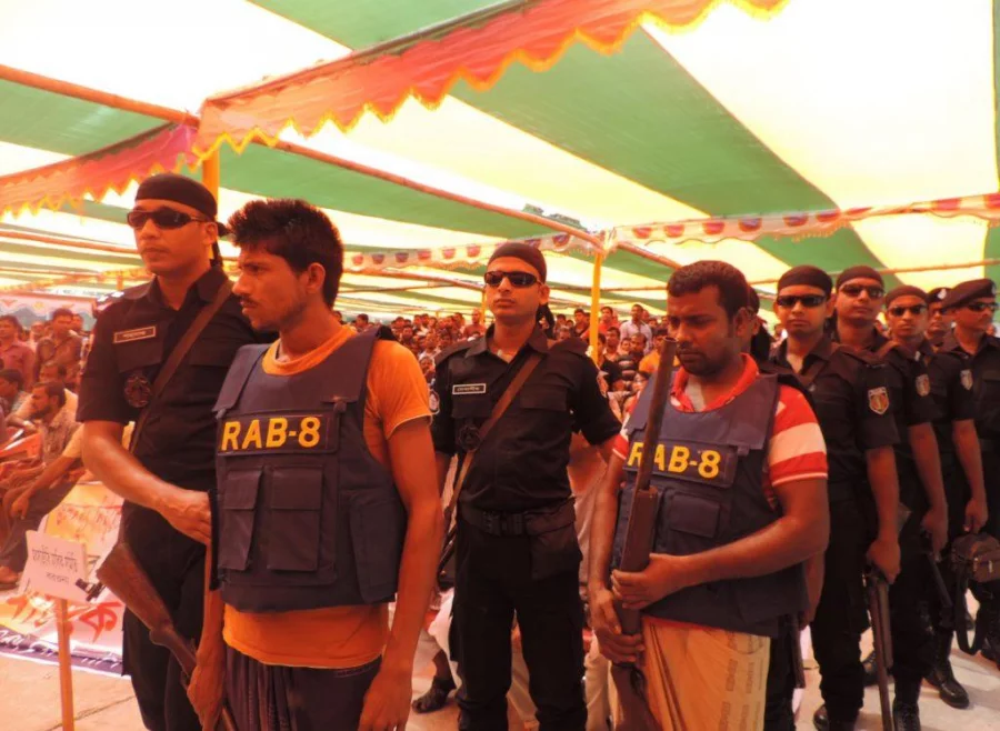 Members of Sagar Bahini being taken to the stage as they surrender to the home minister Thursday
