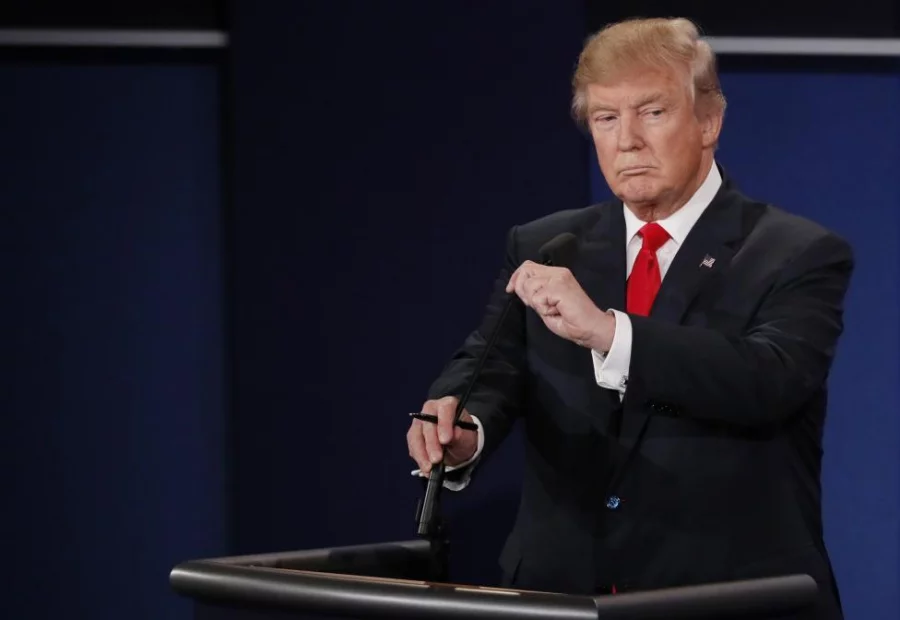 Donald Trump adjusts his microphone before the debate. REUTERS/Mark Ralston/Pool