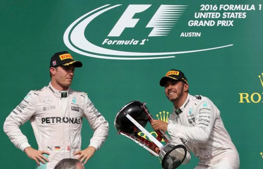 Formula One F1 - U.S. Grand Prix - Circuit of the Americas, Austin, Texas, U.S., 23/10/16. Mercedes' Lewis Hamilton of Britain raises his victory trophy as second placed finisher and teammate Nico Rosberg (L) of Germany looks on during the victory ceremony. REUTERS/Adrees Latif TPX IMAGES OF THE DAY