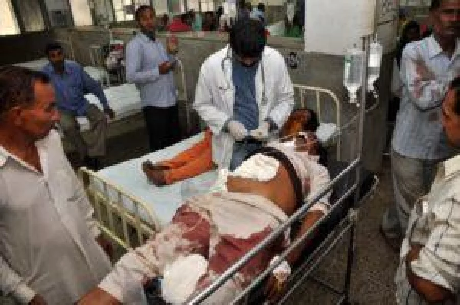 Indian volunteers and officials use a trolley to wheel injured villager Ashok Kumar into The Government Medical College Hospital in Jammu on November 1, 2016, after he was injured in cross-border shelling in the disputed Himalayan region of Kashmir. Indian authorities said seven civilians had been killed after Pakistani mortar shells hit two areas in the disputed Kashmir region, as tensions soar between the nuclear-armed rivals. Two children and three adults were killed in the shelling near the city of Jammu in the Samba sector across the border with Pakistan's Punjab province, a top civil official, Pawan Kotwal, told AFP. / AFP PHOTO / STR