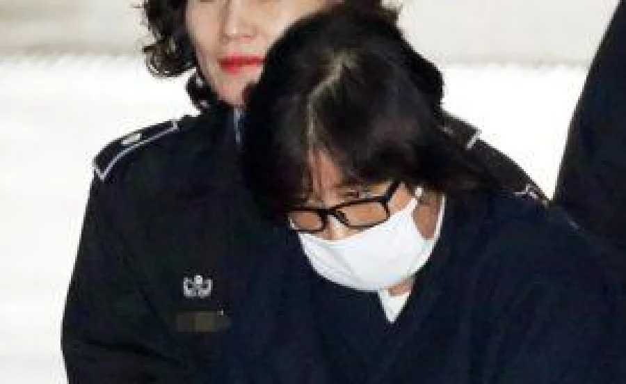 Choi Soon-Sil is escorted into the Seoul Central District Prosecutor's Office in Seoul on November 3, 2016. South Korea's President Park Geun-Hye is scrambling to deflect rising public anger over suggestions that Choi -- the daughter of a shadowy religious figure -- vetted presidential speeches, had access to classified documents, and used her influence for personal enrichment. / AFP PHOTO / YONHAP / Yonhap / - South Korea OUT / REPUBLIC OF KOREA OUT NO ARCHIVES RESTRICTED TO SUBSCRIPTION USE EDITORS NOTE: IMAGES WERE PIXELATED AT SOURCE