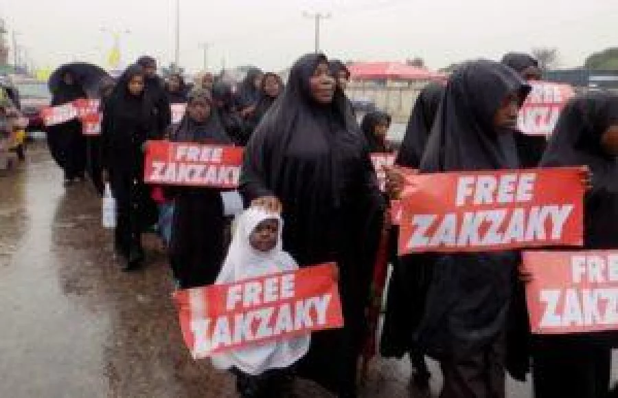 (FILES) This file photo taken on August 11, 2016 in northern Nigerian city of Kano shows protesters from the pro-Iranian Islamic Movement in Nigeria (IMN) marching in the rain through the streets to press for the release of their leader Ibrahim Zakzaky and his wife Zeenat. AFP PHOTO / AMINU ABUBAKAR