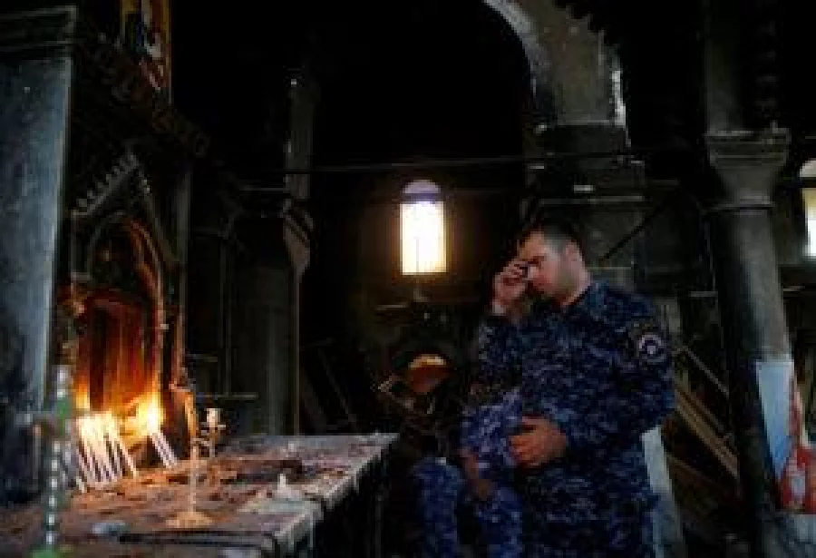 An Iraqi Christian police attends the first Sunday mass at the Grand Immaculate Church since it was recaptured from Islamic State in Qaraqosh, near Mosul in Iraq October 30, 2016. REUTERS