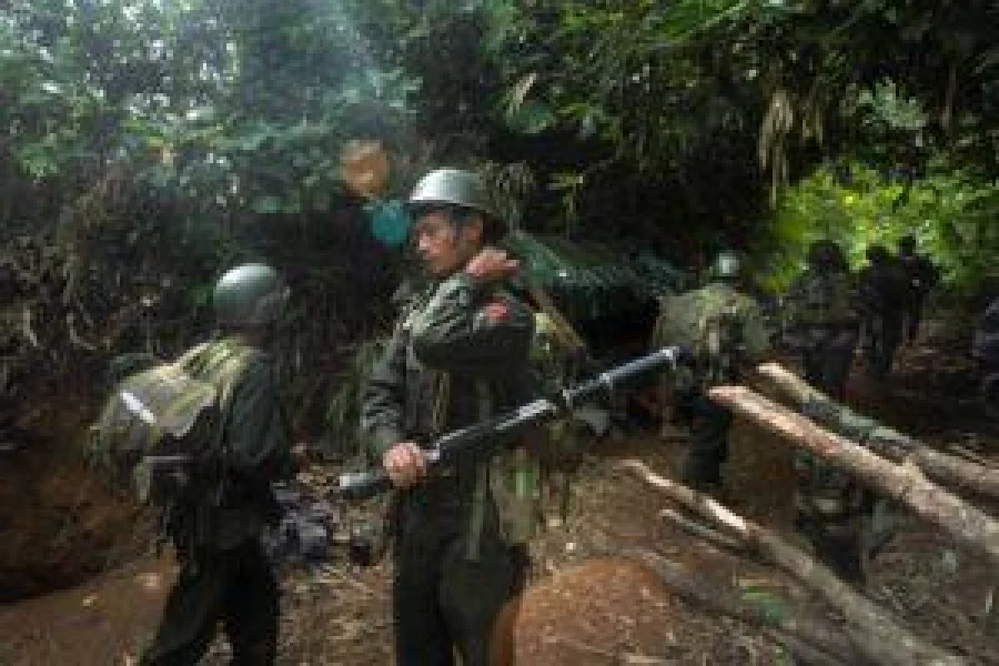 In this file photograph taken October 14, 2016, armed rebels belonging to the Kachin Independence Army (KIA) ethnic group move towards the frontline near Laiza in Kachin state.  / AFP PHOTO / HKUN LAT